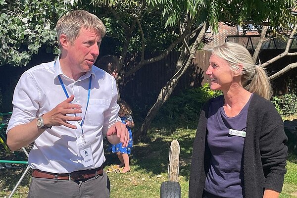 James with a member of staff outside at Blue Door nursery