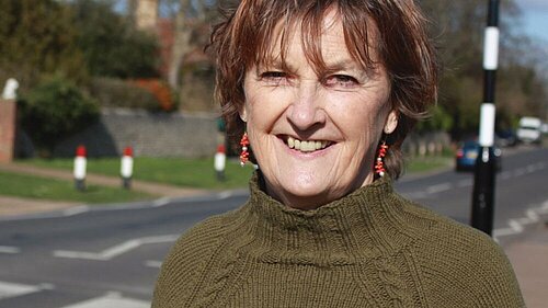 Head and shoulders shot of Councillor Carolyn Lambert with a pedestrian crossing in the background