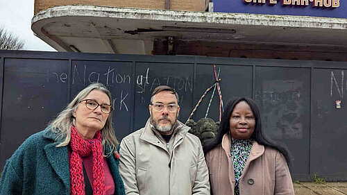 Councillors Edwina Livesey, Kevin West and Janet Baah outside the boarded up and delapidated remains of the bus station