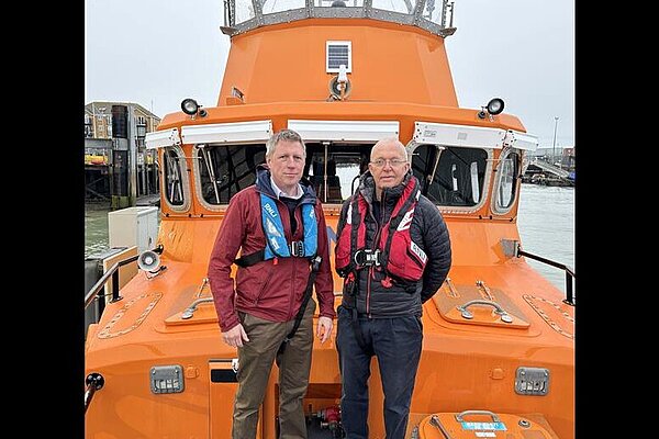 James and the RNLI's Roger Cohen posing for a picture on the deck of a lifeboat