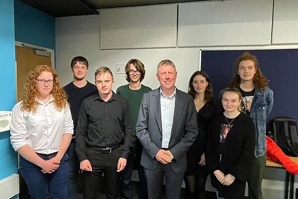 James MacCleary posed for the photo with assorted students at Sussex University Politics Society