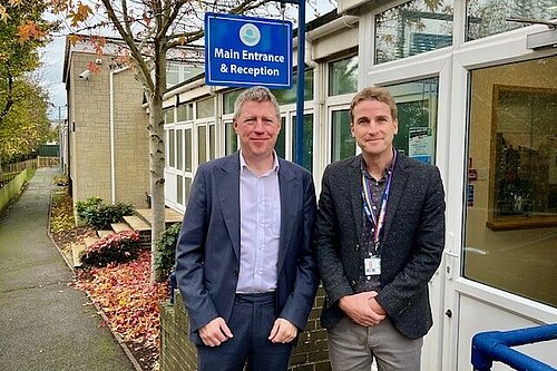 James with the head of Denton Primary School at the school's entrance