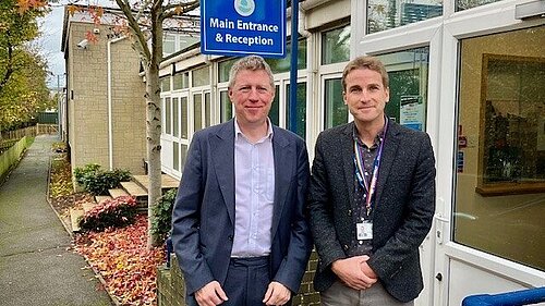 James with the head of Denton Primary School at the school's entrance